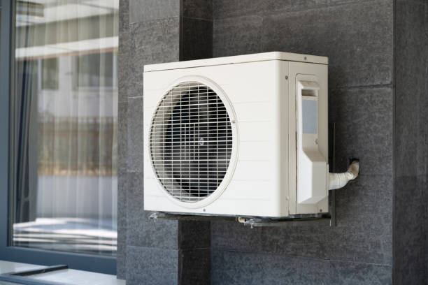 A ductless mini split system is mounted to the side of a home.