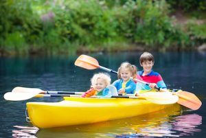 kids in canoe going down a Missouri river