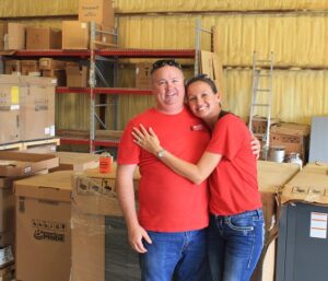 Founder of Jon Wayne Heating & Air with his wife at the fish fry